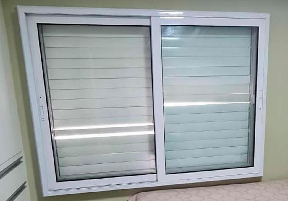 Janela acústica de correr com persiana integrada, instalada em quarto